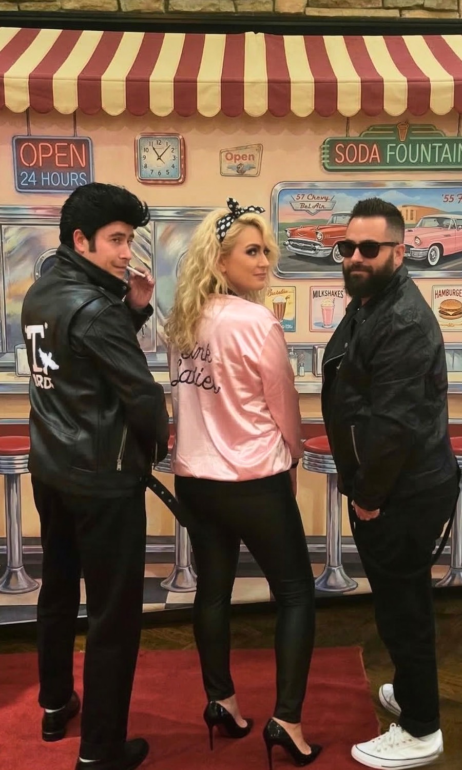 Grease inspired performer full length on a red carpet